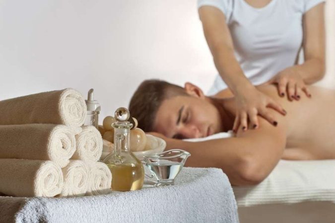 Aromatherapy massage with essential oils and relaxing spa setting